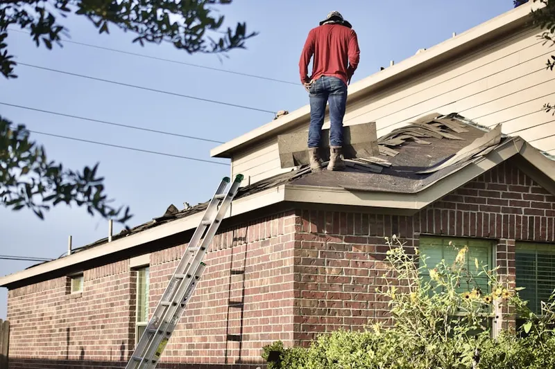 Professional roofer working on a residential roof in Allegany